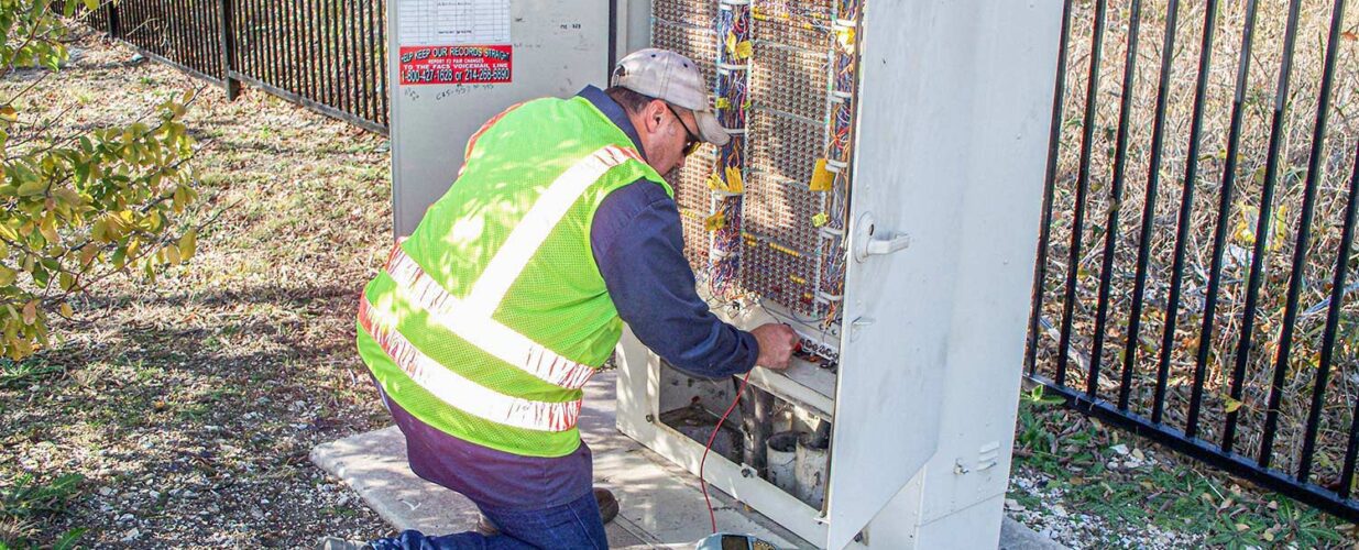 SUE crew member working on electrical box wiring system